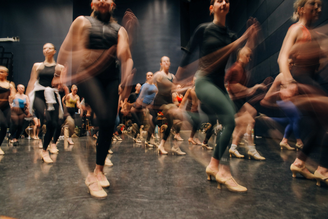 Dancers rehearsing choreography in motion during a workshop