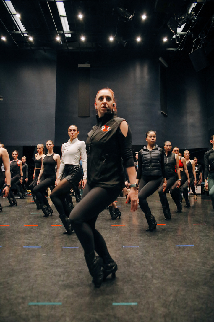 Instructor leading the full room through precision choreography